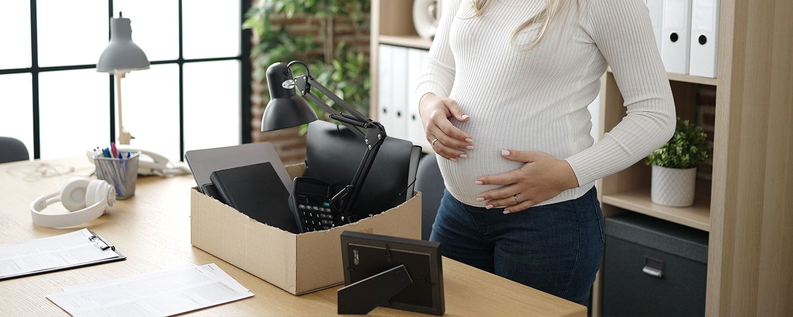 Employee in California holding a termination letter while meeting with a labor lawyer